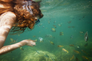 Girl snorkeling in tropical waters