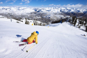 A woman skiing fresh groomers.